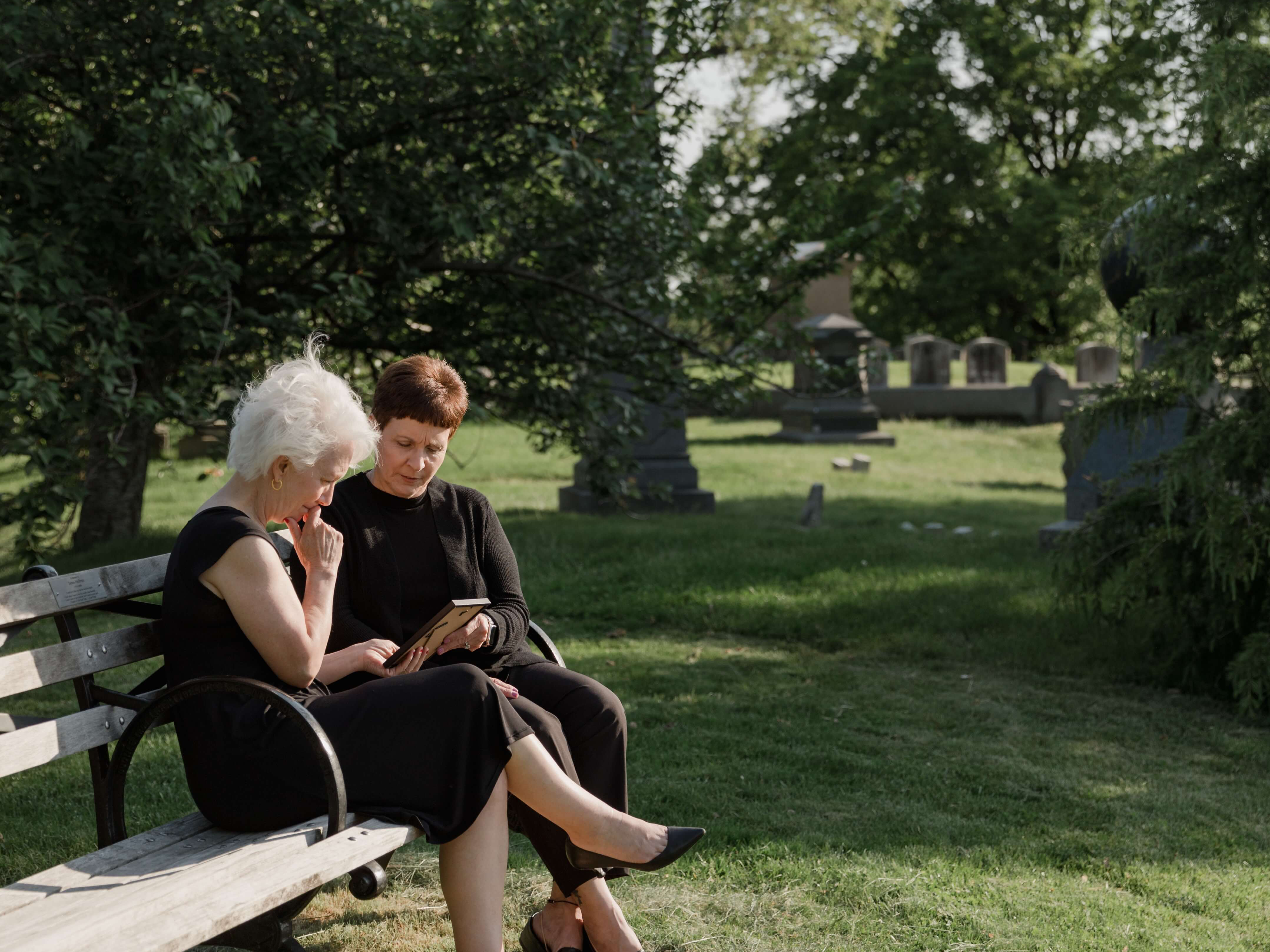 sad family in cemetery